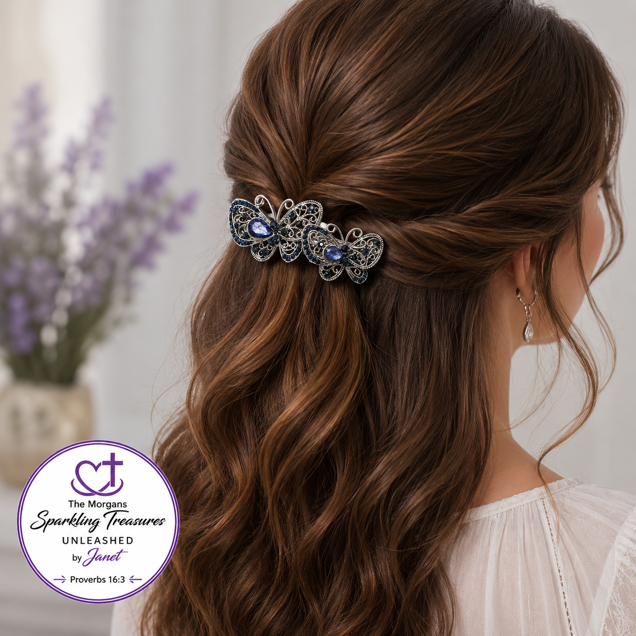 A woman shown from the back wearing a decorative butterfly hair clip in a half-up style. The clip has silver filigree detailing and blue gemstones.