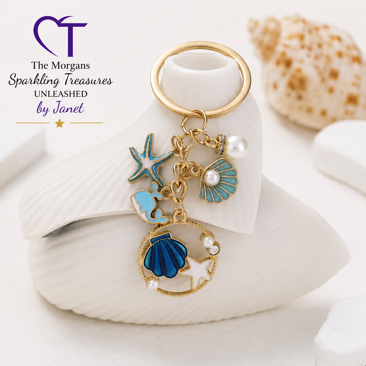 Keychain with sea-themed charms on a shell, featuring 'The Morgans Sparkling Treasures UNLEASHED by Janet' logo.