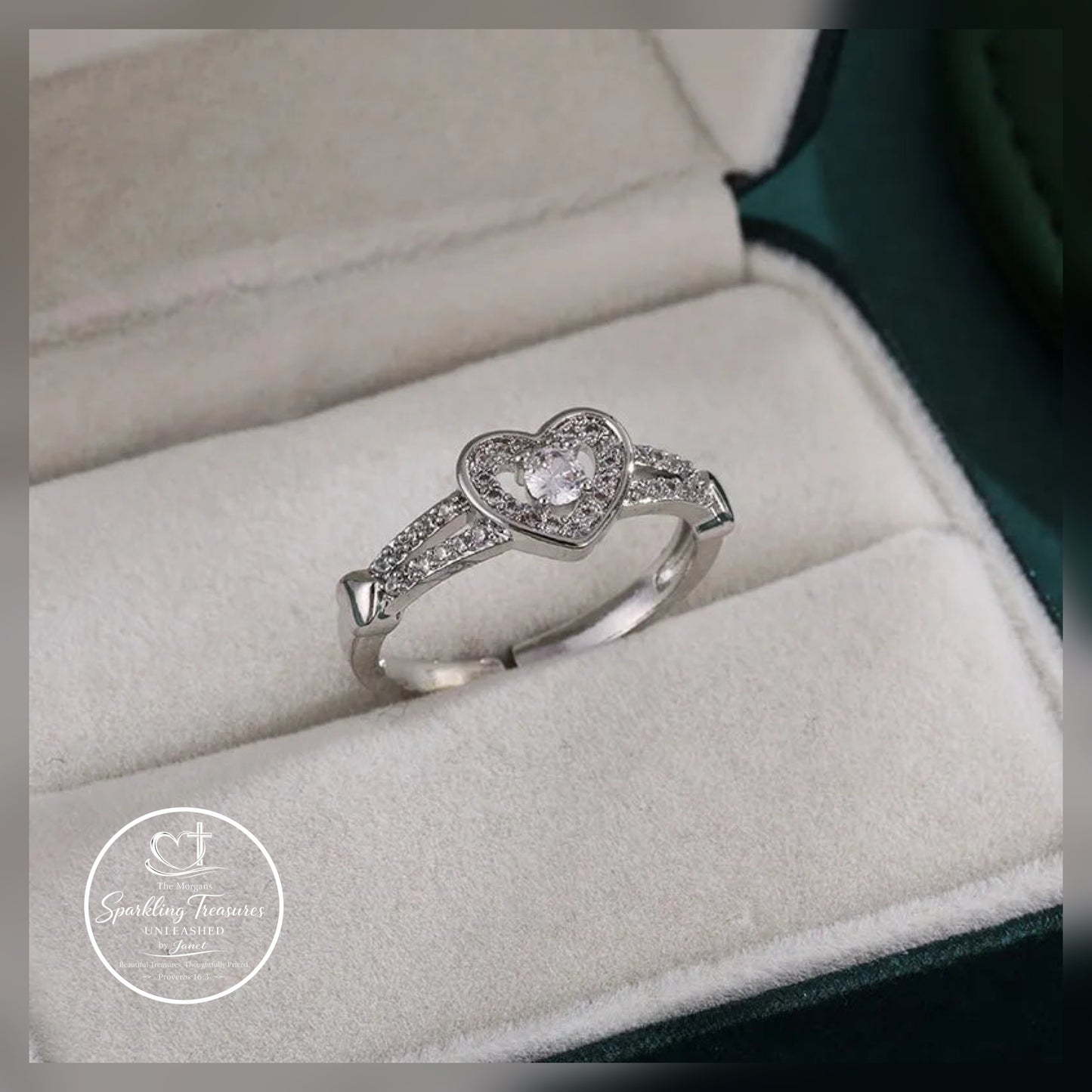 Heart-shaped diamond ring in a jewelry box with 'Sparkling Treasures' logo.