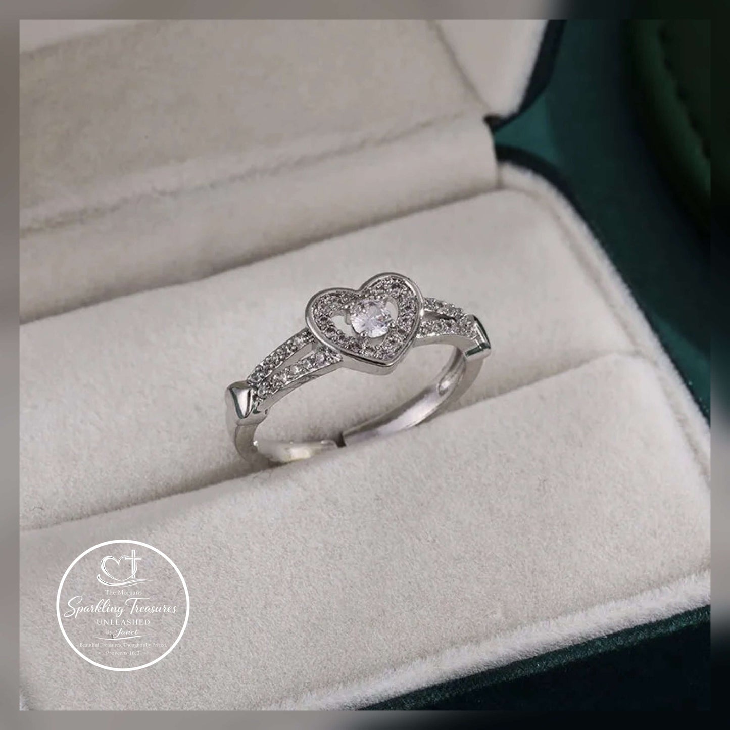 Heart-shaped diamond ring in a jewelry box with 'Sparkling Treasures' logo.