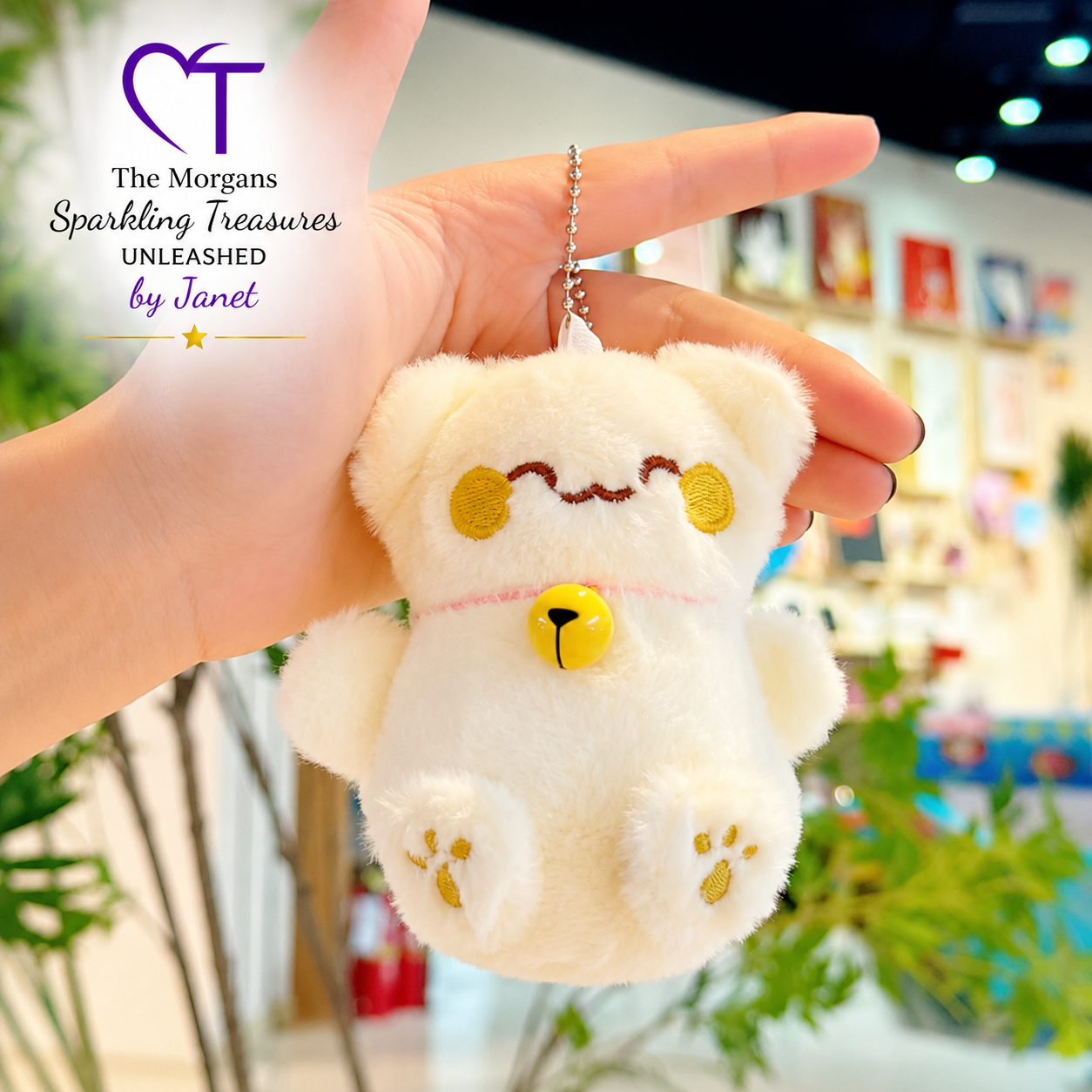 White fluffy keychain with yellow accents held by a hand in a store setting.