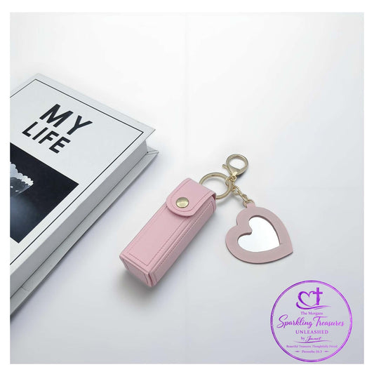 Pink heart-shaped keychain and lip balm case on a white surface with 'My Life' book in the background.
