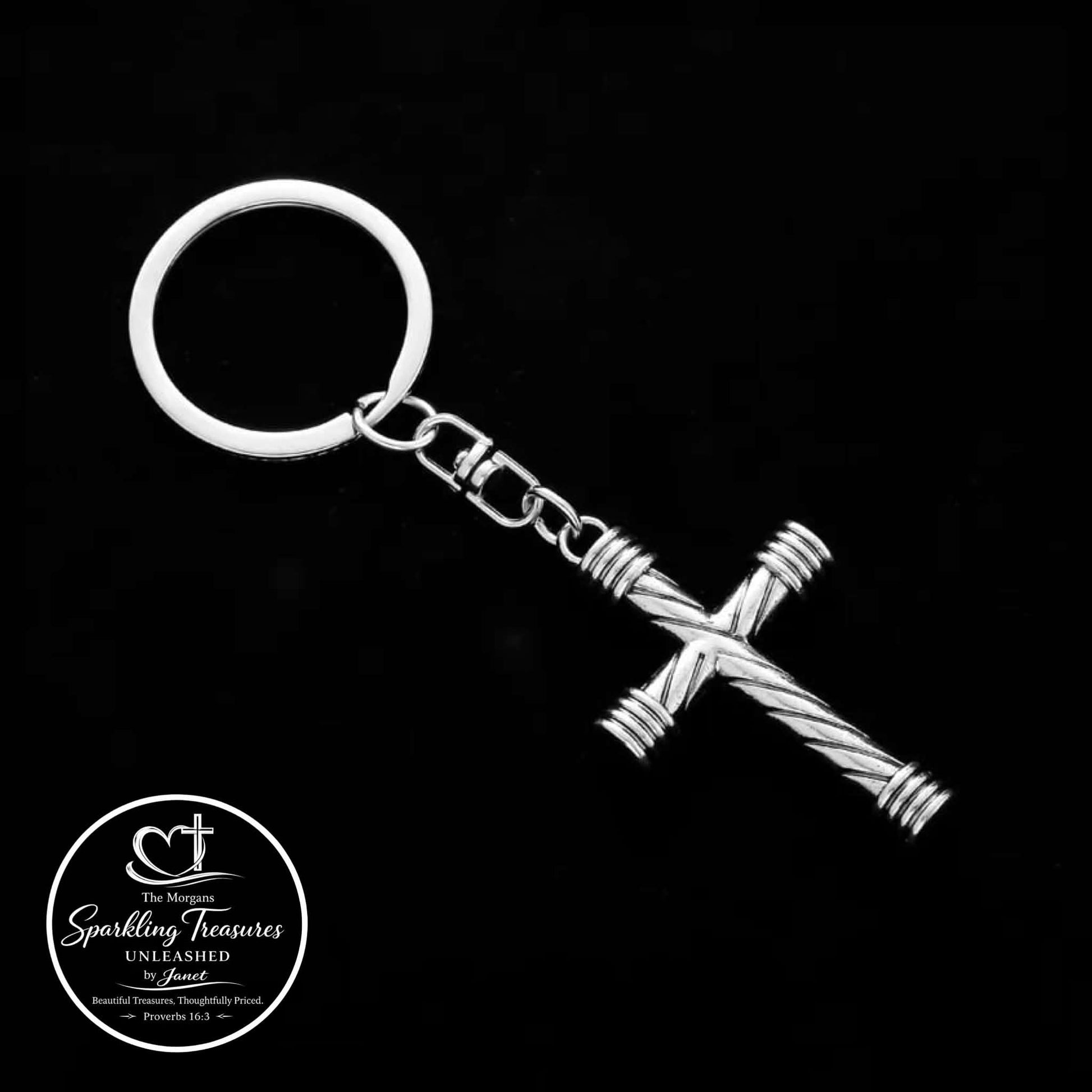 Silver keychain with cross design on a black background, featuring the 'Sparkling Treasures' logo.