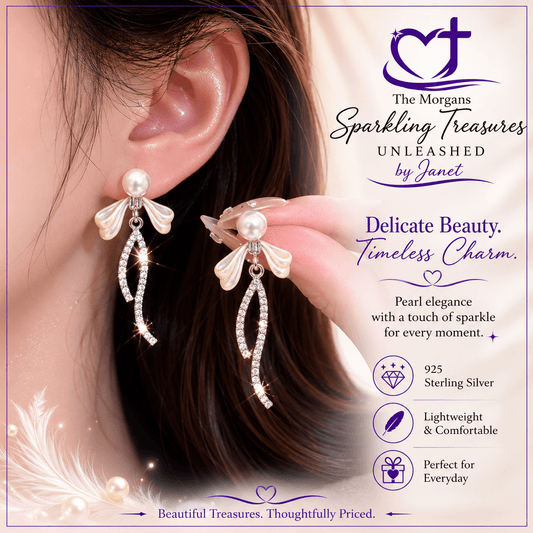 Pearl earrings with silver accents worn by a person, displayed against a soft background with brand information.